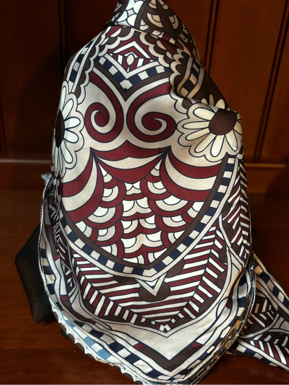 elegant brown, white, and burgundy silk scarf features an ornate floral